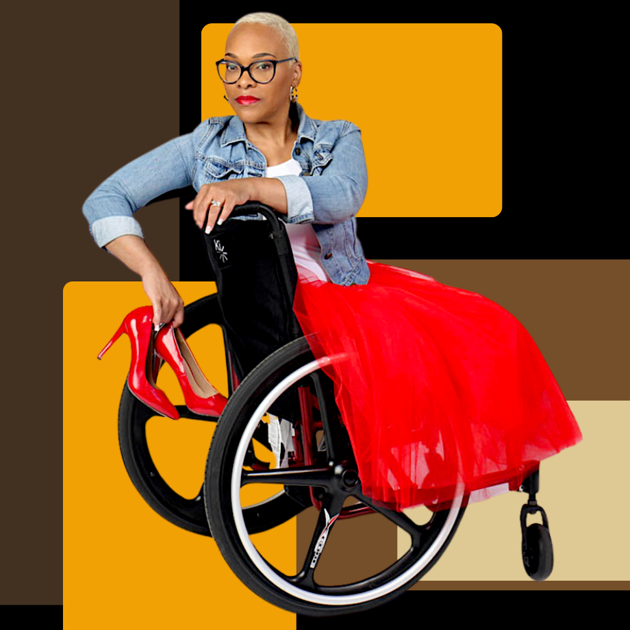 A black woman with light skin and short hair in a wheelchair, wearing a red skirt and holding red high heels.