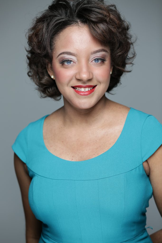 Upper body and head photo of Tyler Samuel, who is wearing a turquoise blouse.